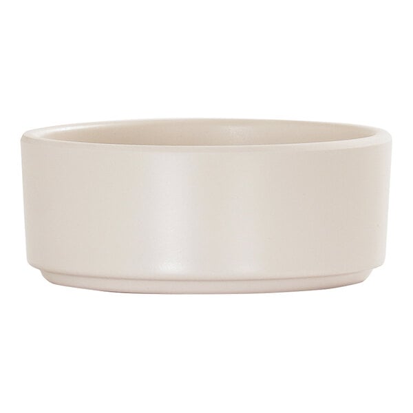 A small, ivory, straight-sided melamine ramekin.