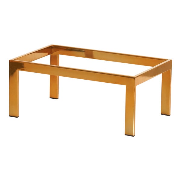 A gold rectangular table with Cal-Mil brass metal display risers.