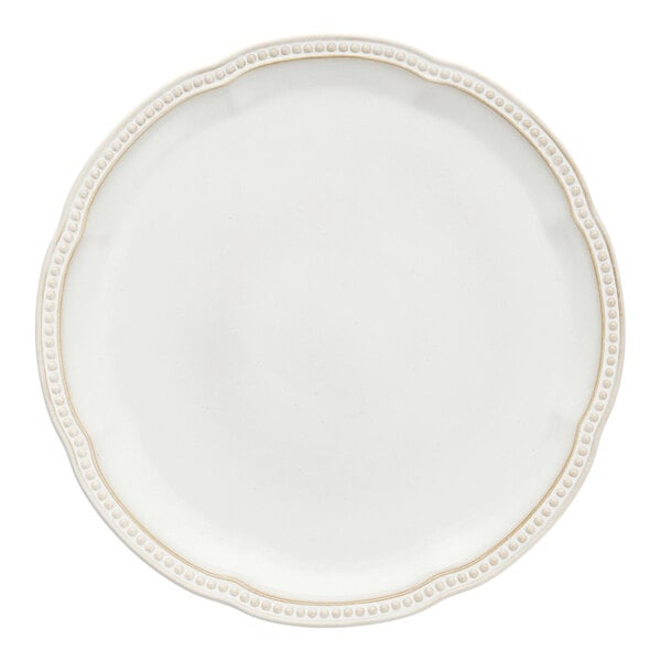 A close-up of a white Mannette Perls charger plate with an embossed pearl border.