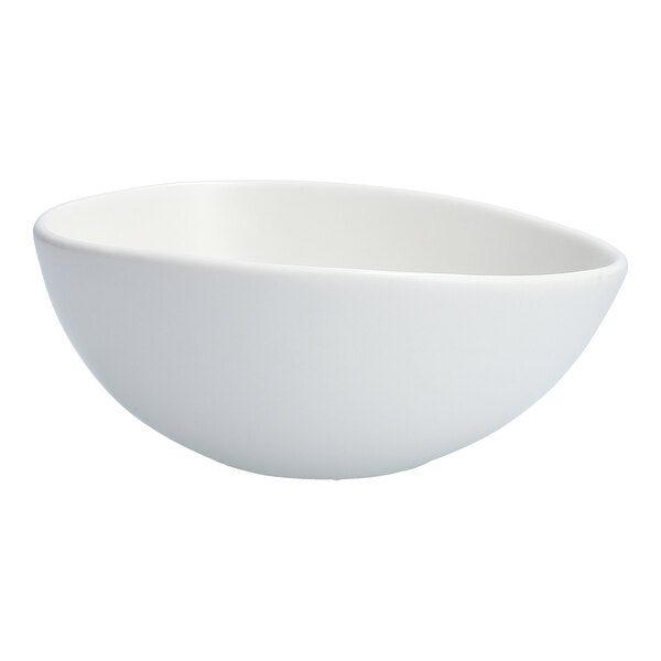An Organica by Fortessa matte white oval bowl with a curved edge.