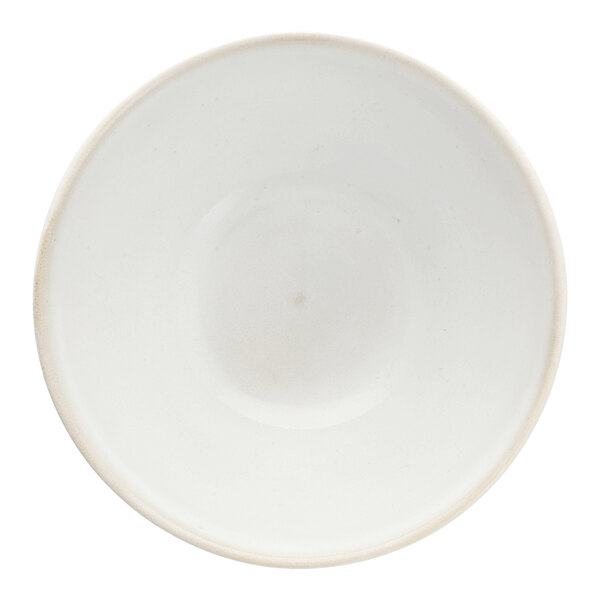 A white stoneware bowl with a scalloped floral edge.