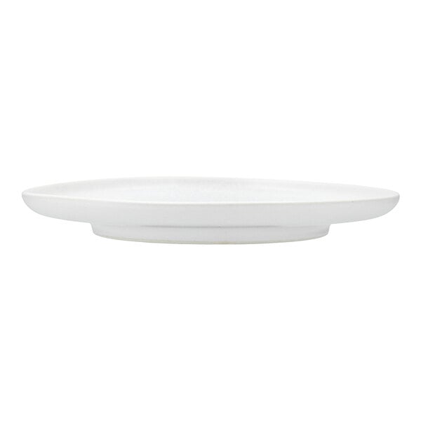 A close-up of a Cloud Terre by Fortessa Iceland white stoneware salad plate with a curved edge.