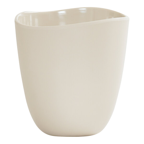 A round ivory melamine dressing crock with a smooth, slightly wavy rim.