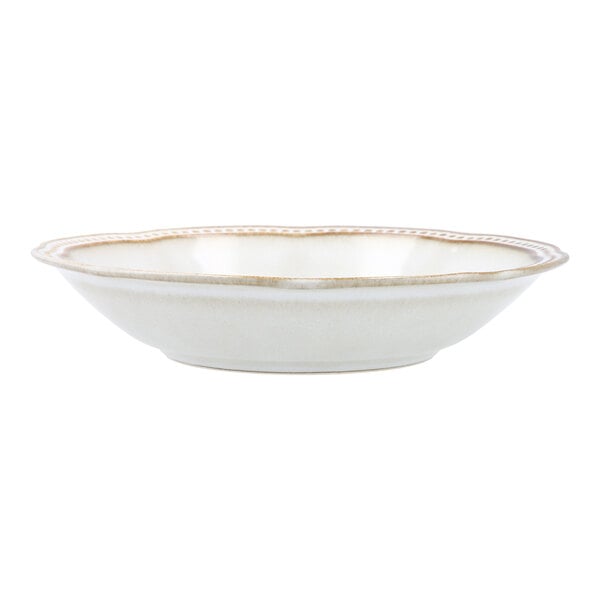 A Mannette Perls by Fortessa white stoneware bowl with an embossed pearl edge and gold trim.