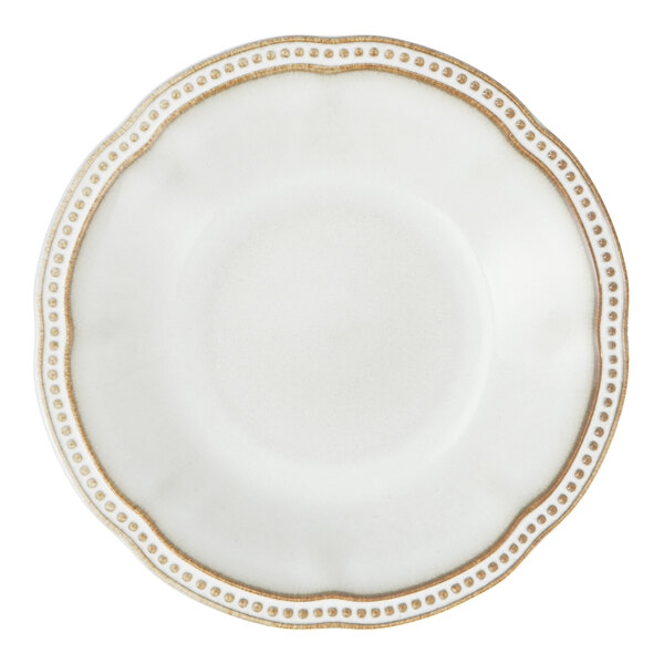 A close-up of a Mannette Perls white stoneware soup plate with an embossed pearl edge.