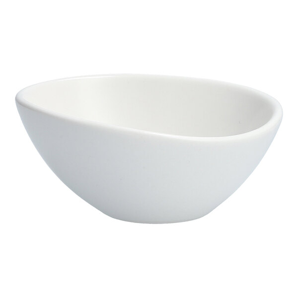 An Organica by Fortessa matte white oval sauce/tasting bowl.