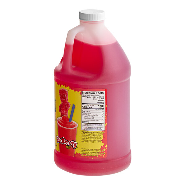 A pink jug of SOUR PATCH KIDS REDBERRY Slushy concentrate with a label.