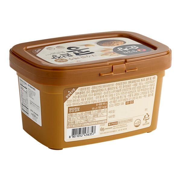 A plastic container of O'Food Doenjang Soybean Paste with a lid and label.