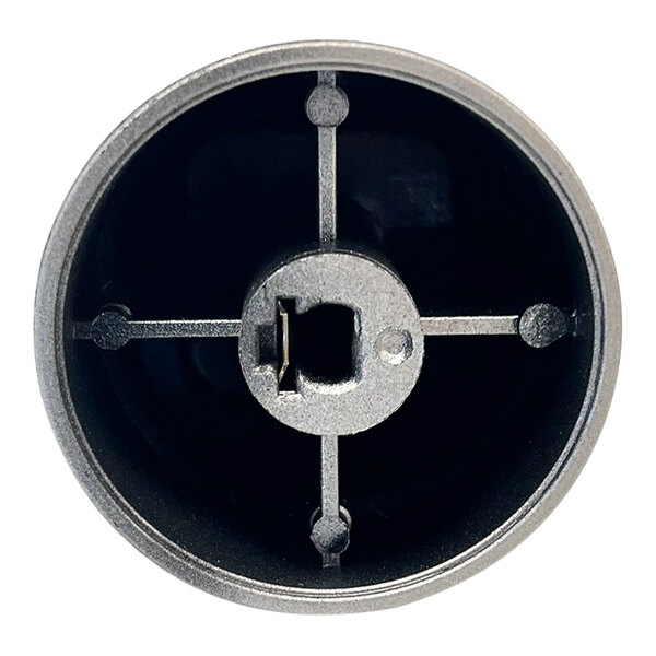 A white metal circular timer knob with a keyhole in the center.
