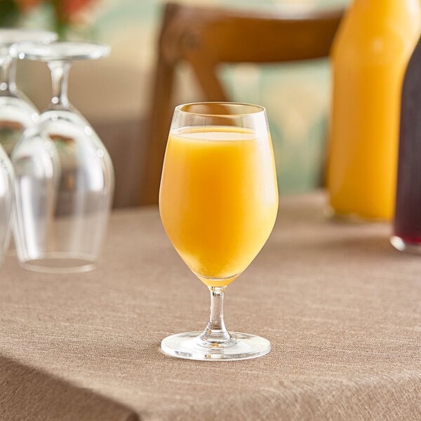 A glass of Nestle Vitality orange juice on a table.