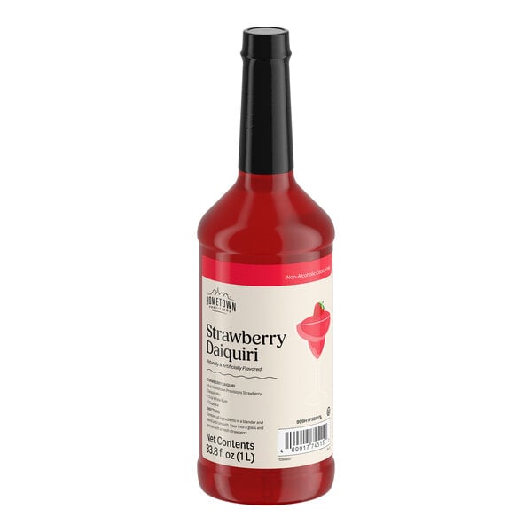 A bottle filled with red liquid and labeled as strawberry daiquiri mix, featuring a black cap and a cream-colored label with a strawberry illustration.