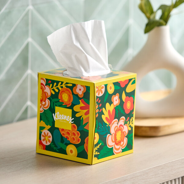 A Kleenex box of tissues with flowers on it.