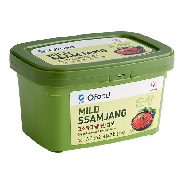 A green container of O'Food Mild Ssamjang Seasoned Soybean Paste with a label.