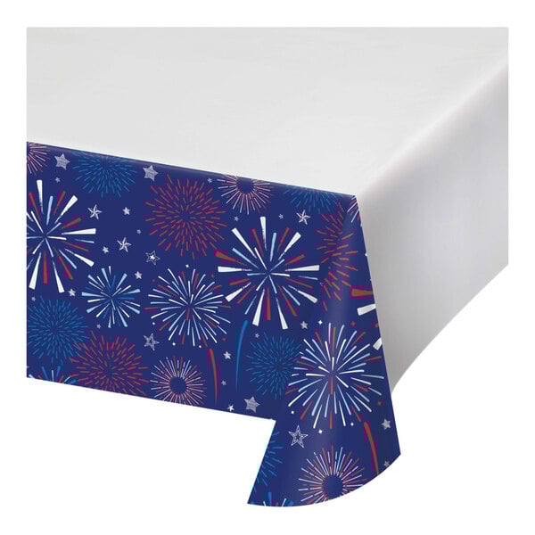 A blue and red fireworks patterned tablecloth with white Lady Liberty silhouettes.