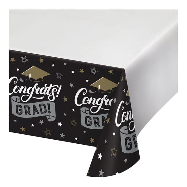 A white paper tablecloth with black and white text that says "Congratulations Graduate" and a black graduation cap.
