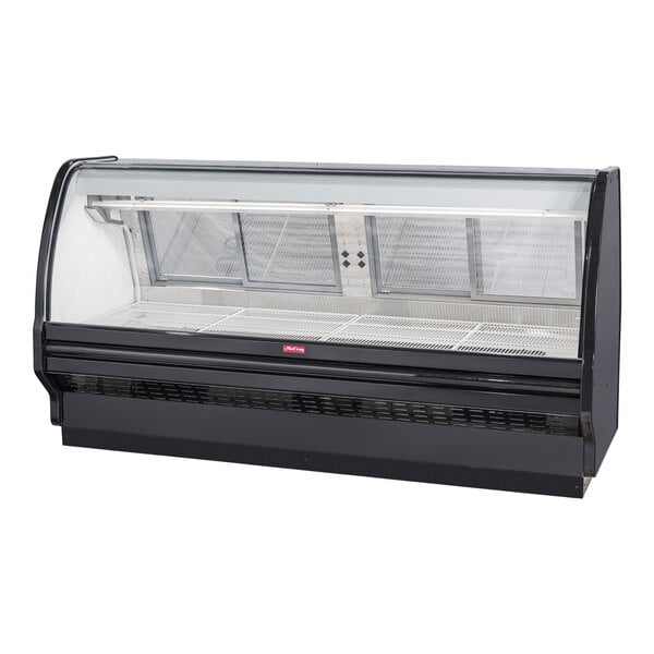 A Howard McCray black refrigerated red meat case with curved glass doors.