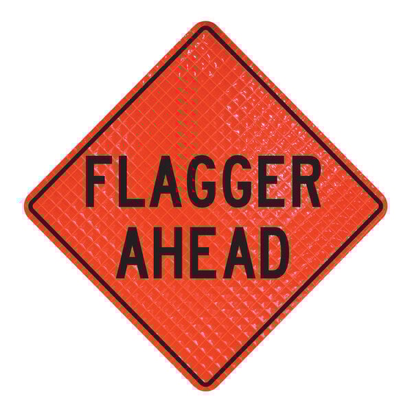A white rectangular sign with a red diamond shape and black text that says "Flagger Ahead" on a Cortina Quadraflex Roll-Up Sign.