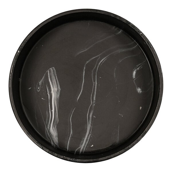 A black round resin bowl with white swirls on it.