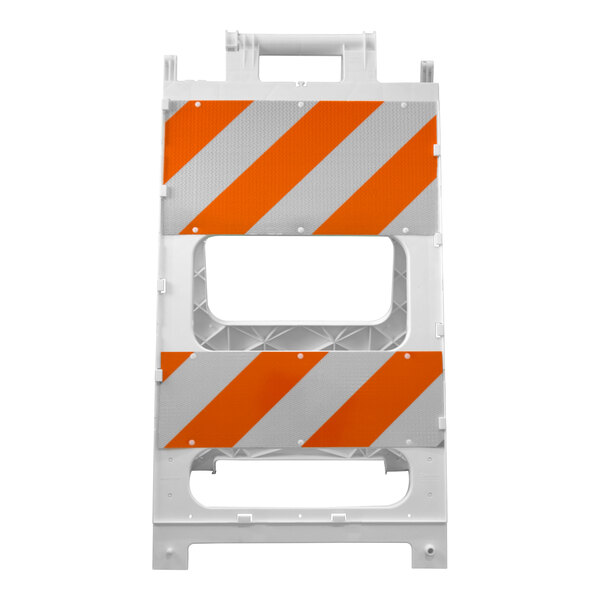 A white plastic barricade with orange and white diagonal reflective stripes.