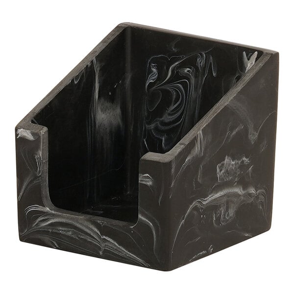 A black swirl resin beverage napkin holder on a counter.