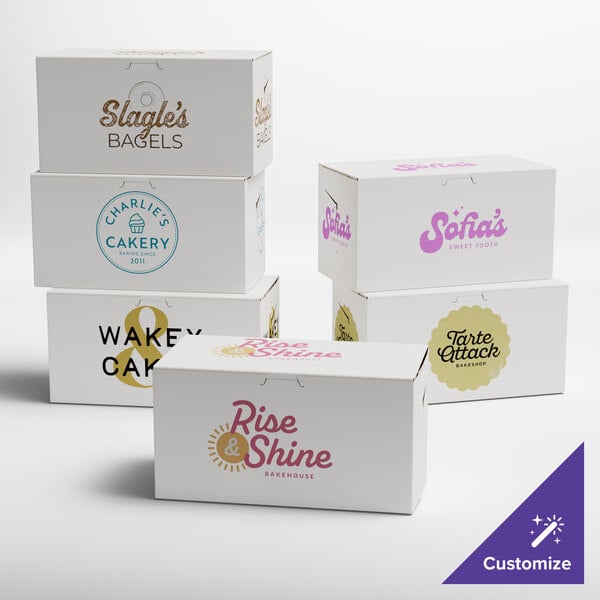 A group of customizable white bakery boxes with various bakery logos printed on them.