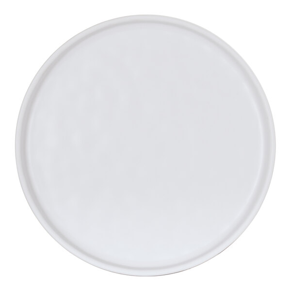 A white Cal-Mil melamine plate with a round rim.