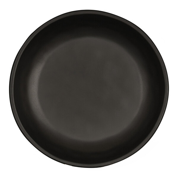 A matte black Cal-Mil coupe melamine bowl with a white rim.