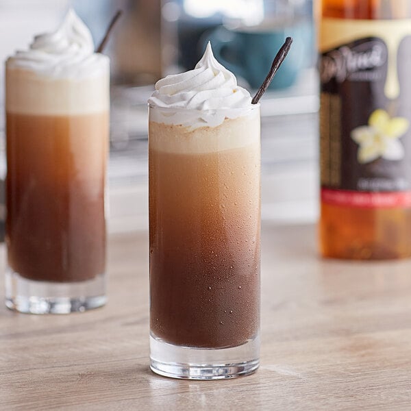 Two drinks made with DaVinci Gourmet Classic Vanilla Flavoring Syrup on a table.