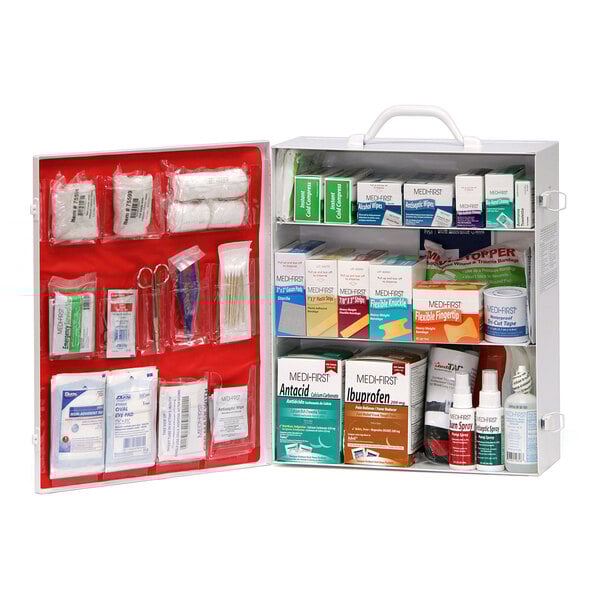 A white and red Medique 3-shelf first aid kit with various items inside.