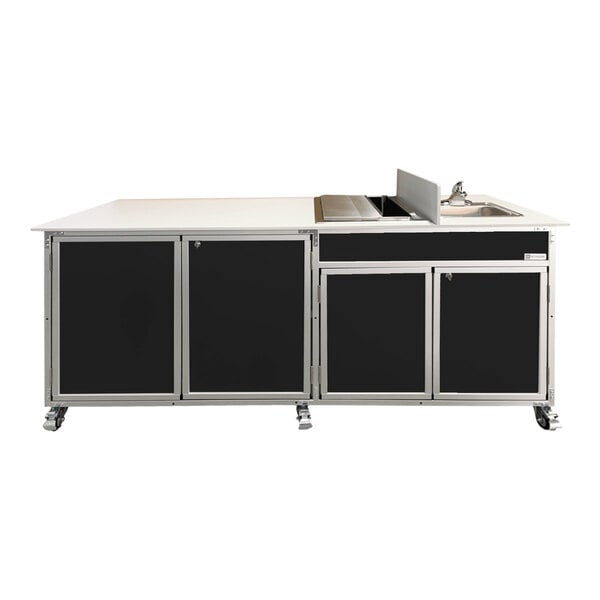 A black Monsam portable self-contained sink with ice bin on a counter in a kitchen.