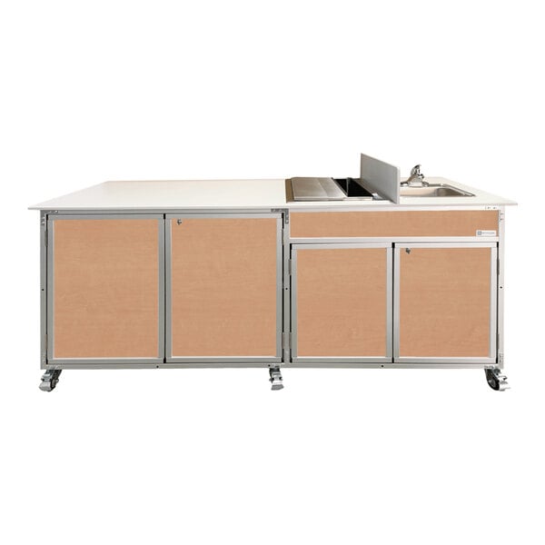 A Monsam portable sink with maple cabinets and an ice bin.
