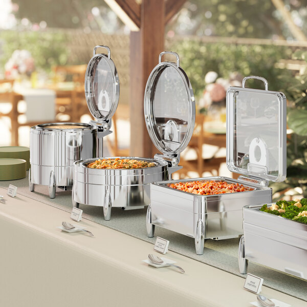 An Acopa Manchester stainless steel chafer with a glass top on a buffet table.