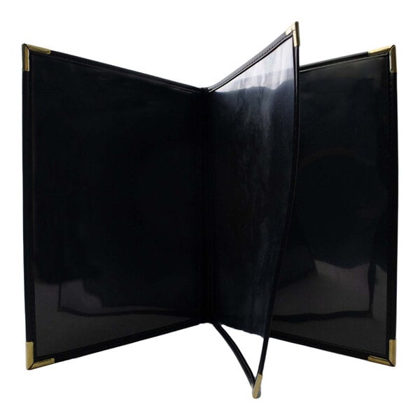 A black linen H. Risch, Inc. menu cover with gold corners.