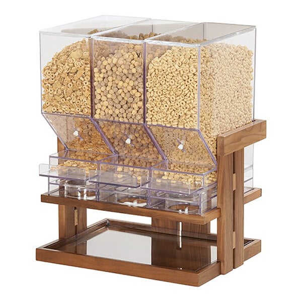 A triple canister cereal dispenser with a walnut wood frame and clear pull-and-serve containers.