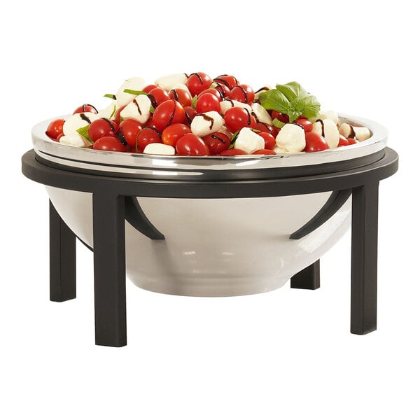 A bowl of food on a Cal-Mil black round riser on a table.