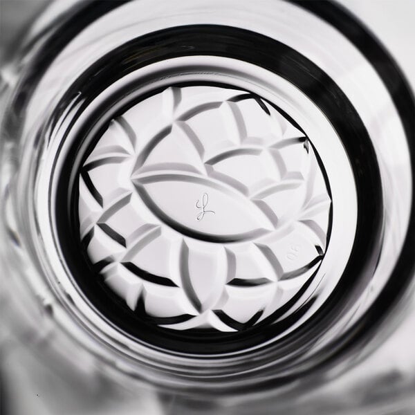 A clear glass with a decorative, textured dahlia pattern on the bottom, designed for serving 10 oz. of beverages.