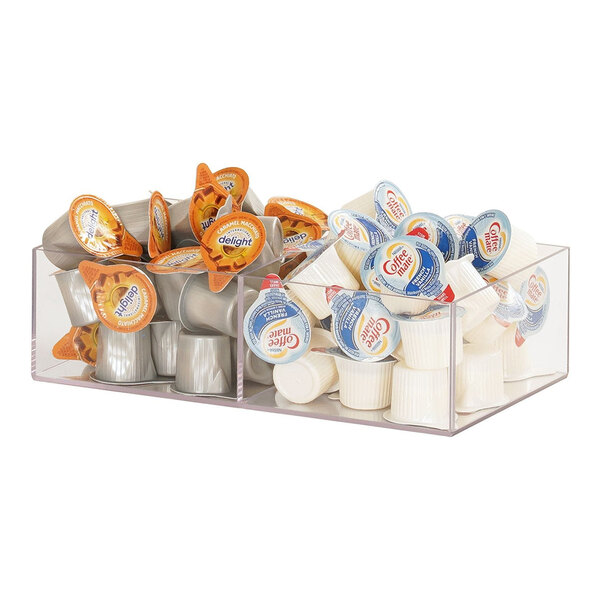 A clear acrylic Cal-Mil organizer with white containers of coffee creamer and yogurt on a counter.
