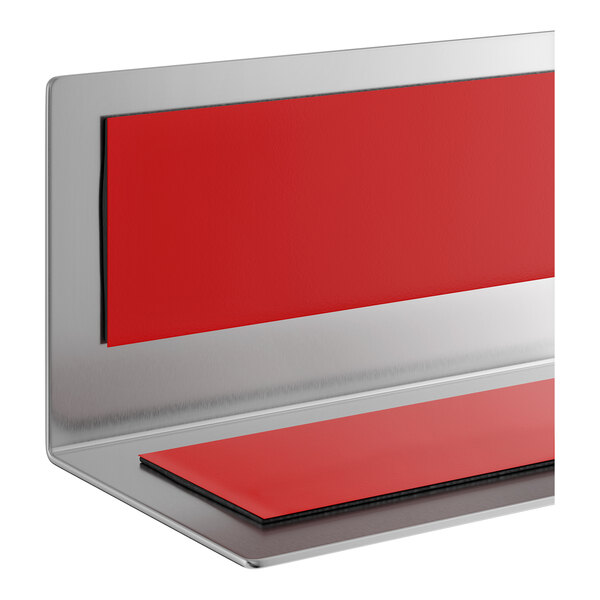 A stainless steel wall corner guard with red protective pads.