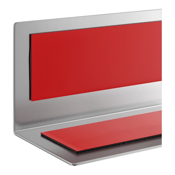 A stainless steel wall corner guard with red protective pads.