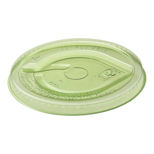 A green compostable plastic flat lid with a straw hole designed for 9-24 oz. cold cups.