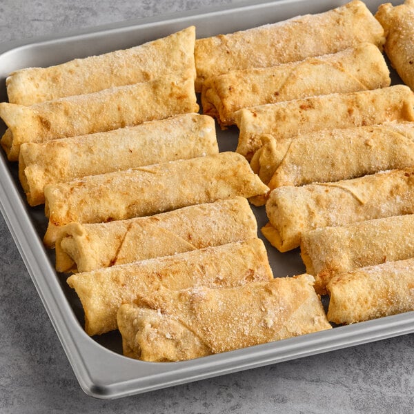 A tray of frozen supreme pizza log egg rolls arranged in rows.