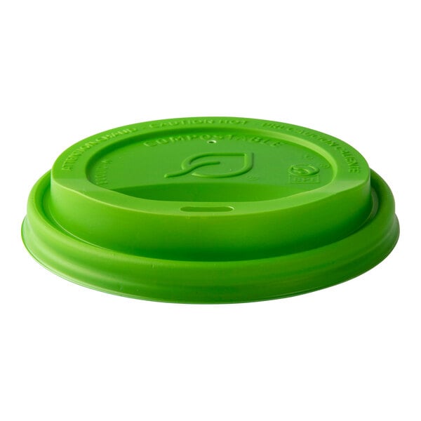 A green compostable plastic sip lid for hot cups.