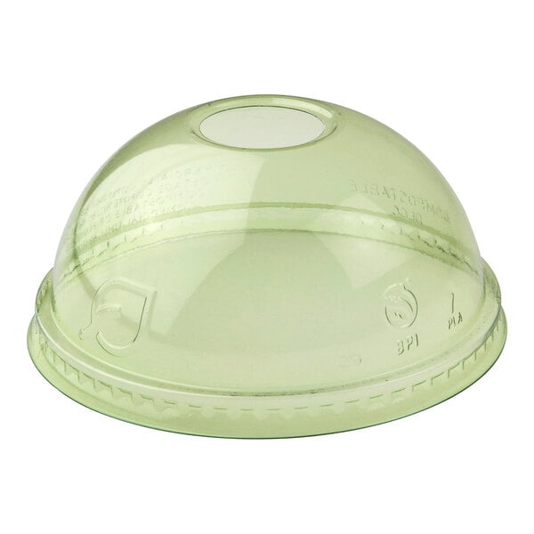 A green compostable plastic dome lid with a straw hole designed for cold cups.