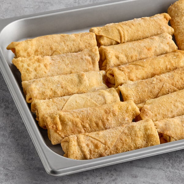 A tray of frozen pepperoni pizza log egg rolls arranged in rows.