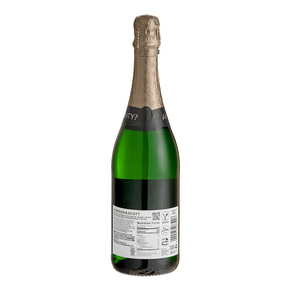 A green glass bottle of Noughty Non-Alcoholic Sparkling Chardonnay with a gold foil-wrapped neck and a label on the back.