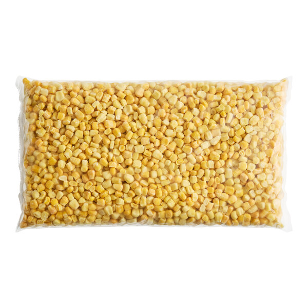 A sealed plastic bag filled with frozen sweet yellow and white corn kernels.