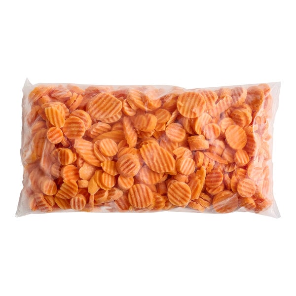A clear plastic bag filled with crinkle-cut carrot slices.