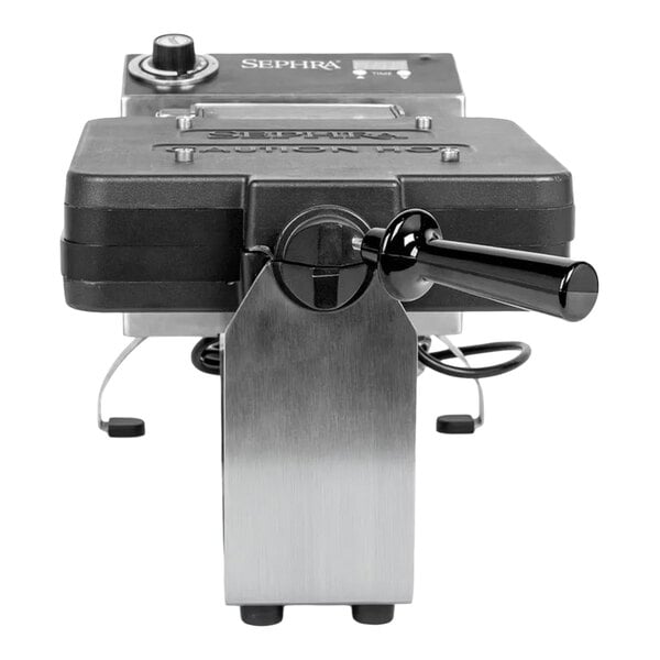 A commercial waffle maker with cast iron and stainless steel construction, featuring non-stick waffle ball plates and a handle.