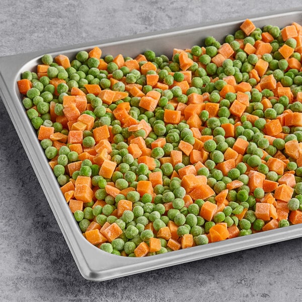 A tray of individually quick frozen (IQF) peas and diced carrots.