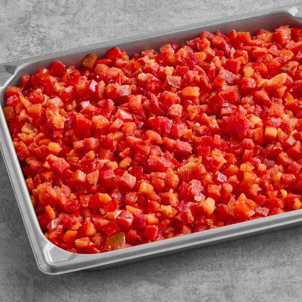 A metal tray filled with individually quick frozen diced red peppers.